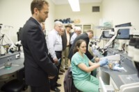 Group of tem watch medical professionals analyze bones in the EVMS Temporal Bone Lab